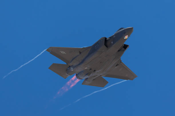 istock F-35 Lightning II  approaching  with afterburner on and condensation trails at the wings tip 1212394565