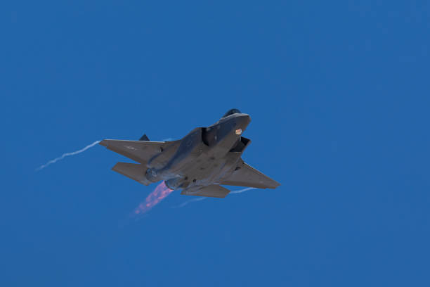istock F-35 Lightning II  approaching  with afterburner on and condensation trails at the wings tip 1212394579