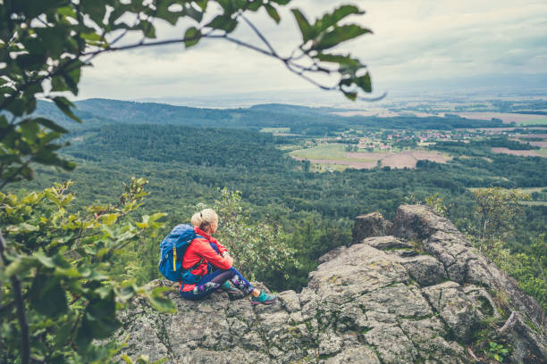 istock Hiking woman with backpack, looking at view 1212394586
