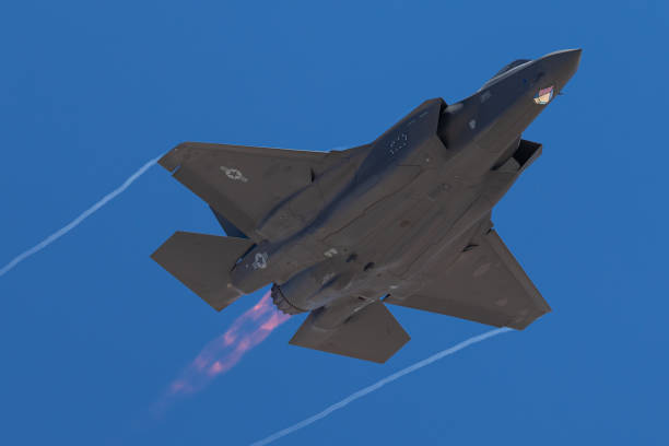 istock F-35 Lightning II  approaching  with afterburner on and condensation trails at the wings tip 1212394726