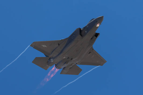 istock F-35 Lightning II  approaching  with afterburner on and condensation trails at the wings tip 1212394754