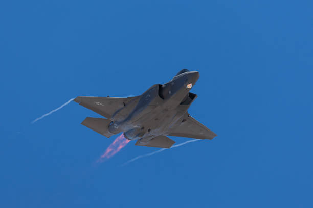istock F-35 Lightning II  approaching  with afterburner on and condensation trails at the wings tip 1212394869