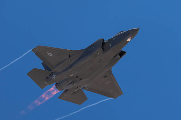 istock F-35 Lightning II  approaching  with afterburner on and condensation trails at the wings tip 1212394886