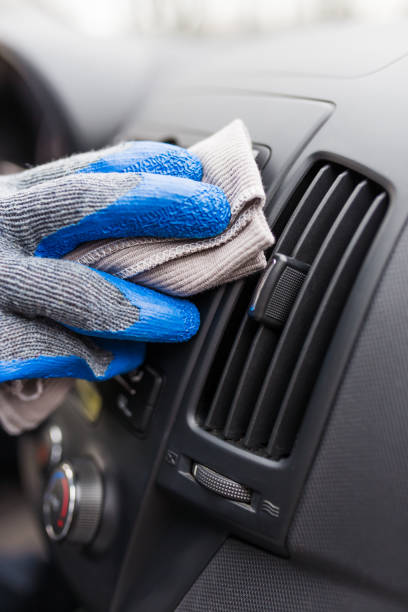 istock Auto service staff hand cleaning car interior with microfiber cloth. Car detailing and valeting concept 1212395895