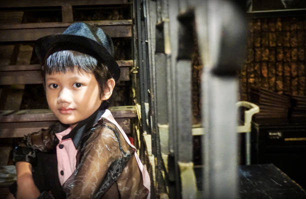 istock Indonesian Boy sitting on the front steps of his home. 1212399773