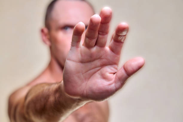 istock Scared man put his hands forward. Athlete fenced off 1212400556