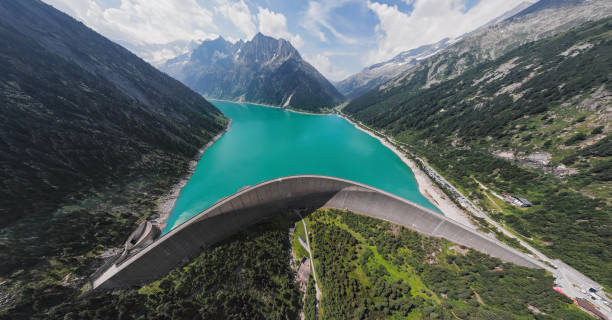 Wide angle aerial panorama of Schlegeis Stausee reservoir dam and panoramic Alpine Road in the Zillertal Alps, Tirol, Austria. Aerial panorama of Schlegeis Stausee dam, Austria. zillertaler alps stock pictures, royalty-free photos & images