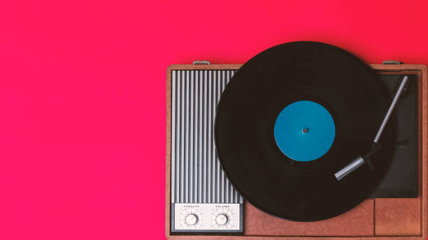istock Retro vinyl player and record player on a red background 1212402876