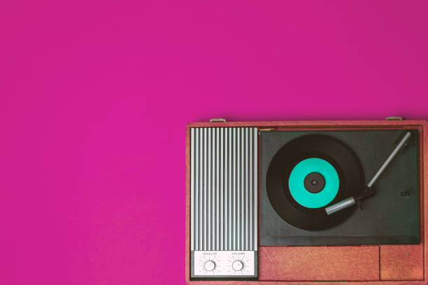 istock Retro vinyl player and record player on a fuchsia background 1212402881