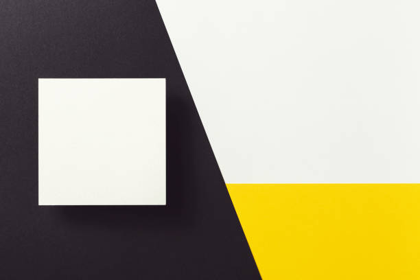 istock White business card on black, yellow and white background. 1212404888