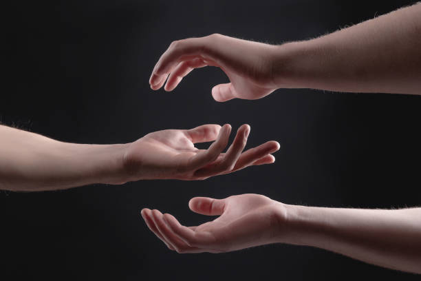 istock touch of 2 x male hands on a gray background 1212404966