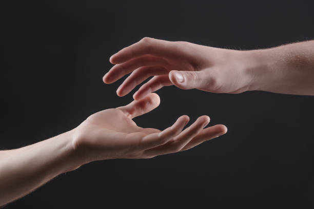 istock touch of 2 x male hands on a gray background 1212404970