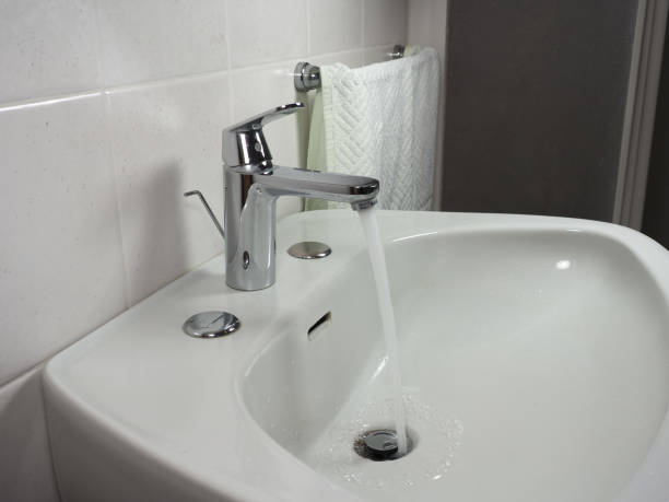 istock tap faucet in basin 1212405099