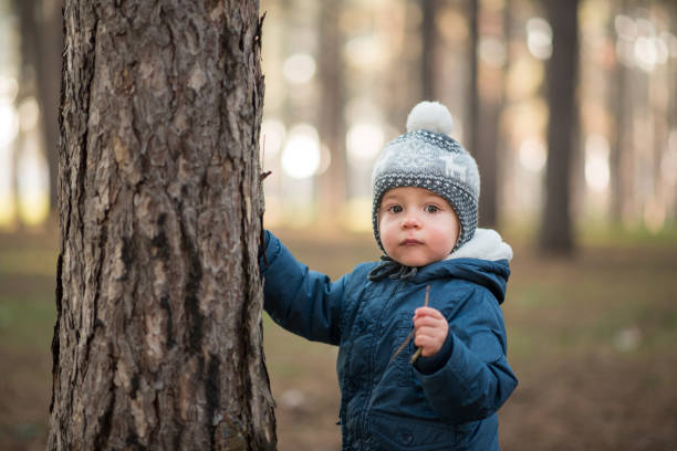 istock Baby boy playing outside and looking at camera 1212406496