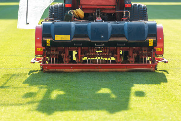 tractor aerating a soccer field - lawn mower red plant lawn imagens e fotografias de stock