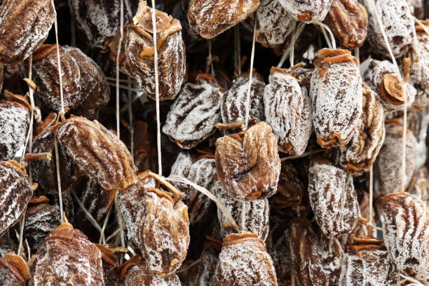 istock Dried persimmon suspended on a ropes 1212414593