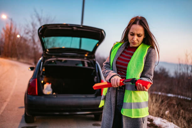 istock Woman placing emergency triangle 1212415703