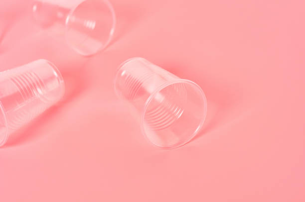 istock Disposable plastic glasses scattered on pink background. Concept of save environment, ecology, recreation on picnic, party and other events. Copy space 1212416990
