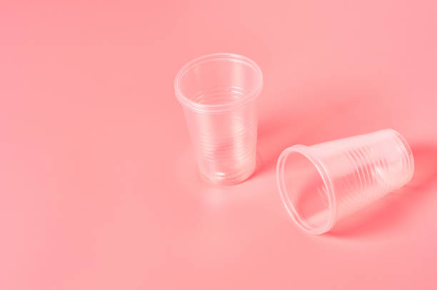 istock Disposable plastic glasses scattered on pink background. Concept of save environment, ecology, recreation on picnic, party and other events. Copy space 1212417007