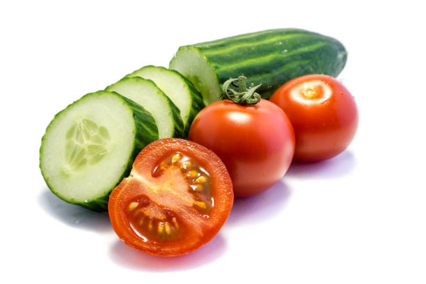 istock Cucumber and tomato isolated on white background 1212419021