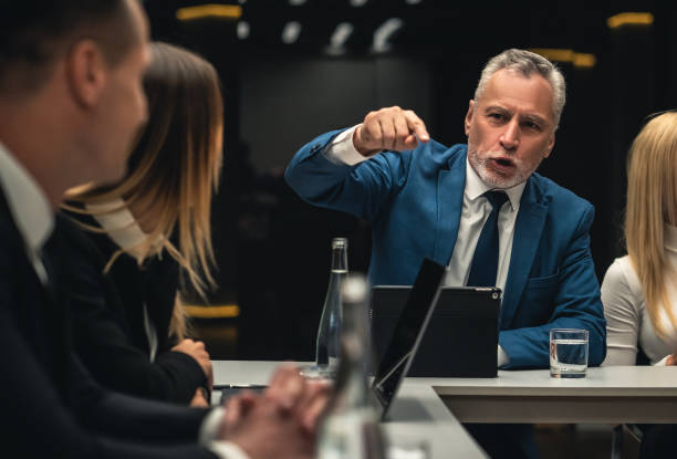 ビジネス会議で話し合う人たち - manager anger table furious ストックフォトと画像