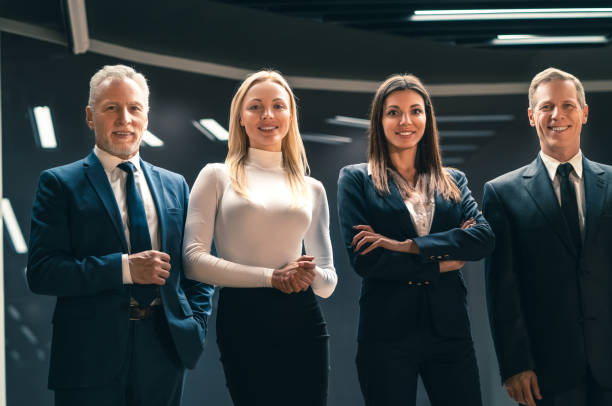 The businesspeople standing indoor