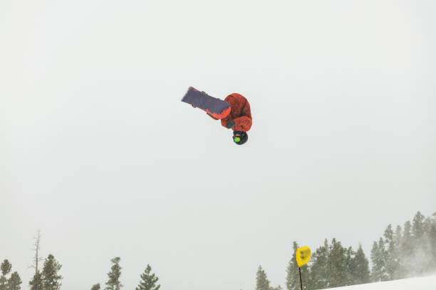 skiing and snowboarding activities at ski resort town in the colorado rockies - ski jumping snowboarding snowboard jumping imagens e fotografias de stock