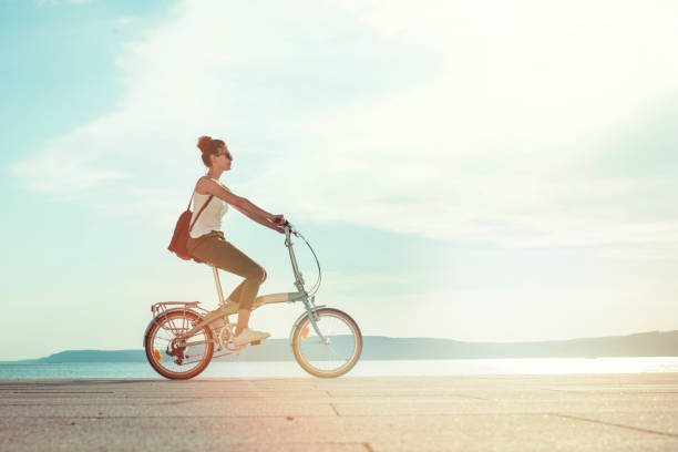 istock young woman using bicycle in the city 1212422812