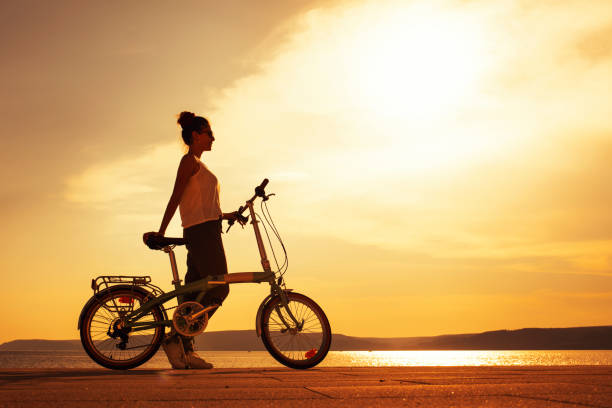 istock young woman using bicycle in the city 1212423421