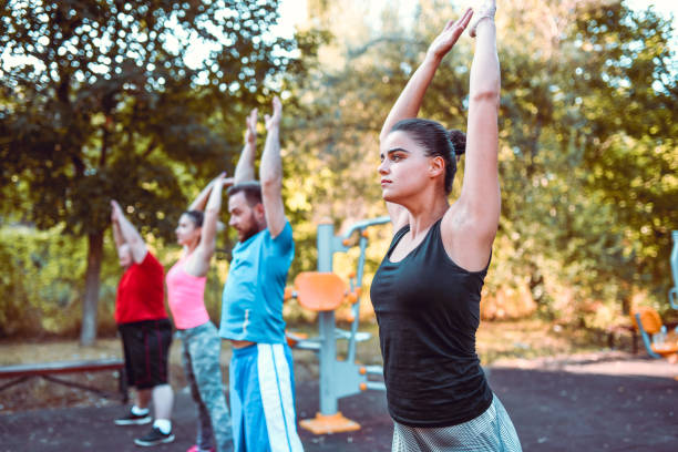 istock Group Of Friends Warming Up For Park Workout 1212423502