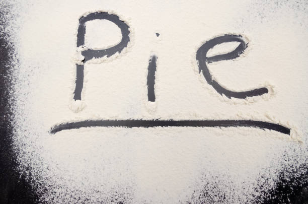 istock word Pie is written on a black background with the flour. Inscription. 1212424770