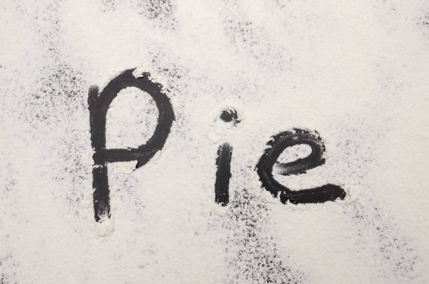 istock word Pie is written on a black background with the flour. Inscription. 1212424862