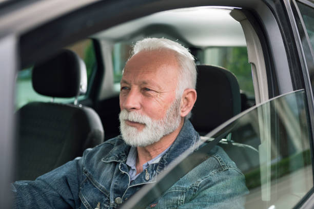 istock Senior man driving a car to work 1212424881