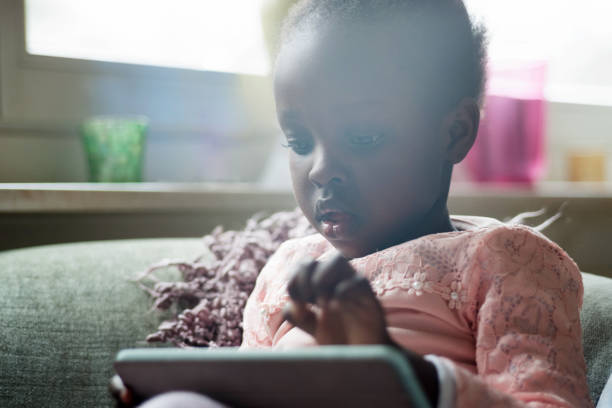 istock female toddler looking at touchpad 1212425633