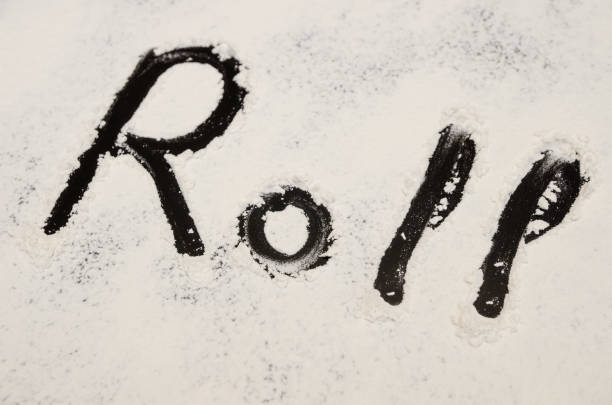 istock words Roll written on a black background with flour. Inscription. 1212425831