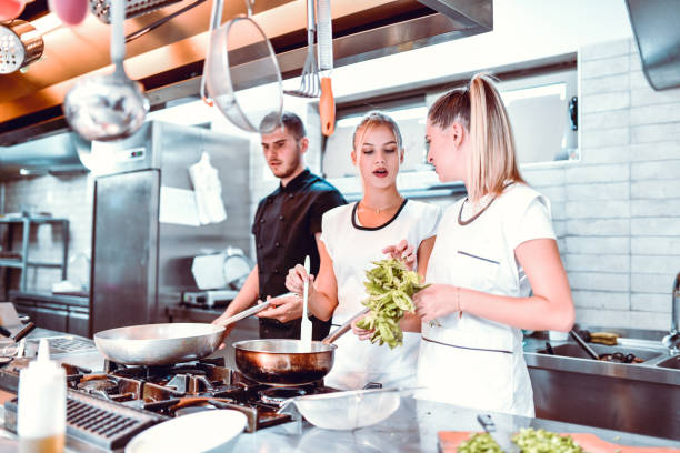 Females Learning From Each Other About Different Leafy Vegetables In Kitchen