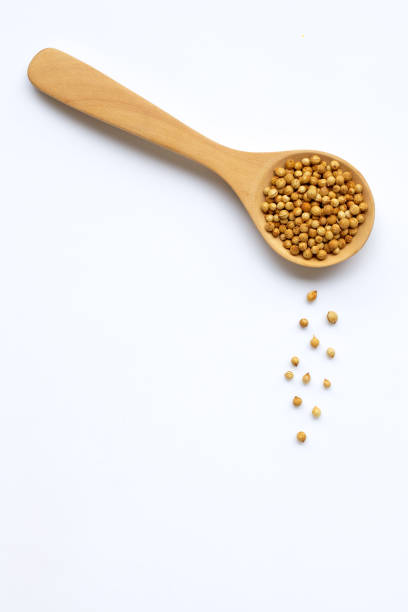 istock Coriander seeds in the wooden spoon on white 1212426773