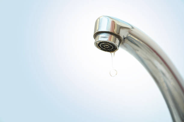 istock fountain and dripping water with blue background 1212436727