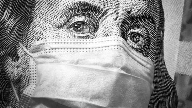 istock COVID-19 coronavirus, finance and crisis concept, US president Franklin`s eyes and face mask on 100 dollar money bill. Corona virus affects global stock market. 1212437607