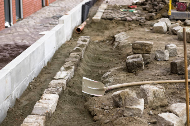 istock Construction site, crafts, road construction, pavement. Laying granite cubes on concrete 1212438358