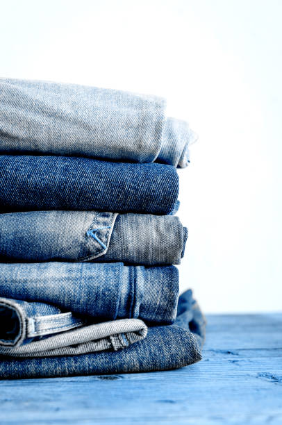 istock Jeans stacked on a wooden table 1212440427