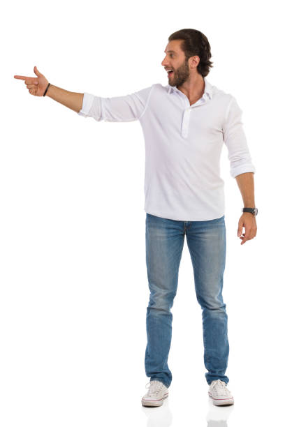 istock Young Man Is Standing, Pointing At Te Side And Talking 1212440734