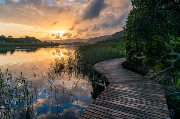 istock River sunset landscape with beautiful clouds, water reflection 1212440750