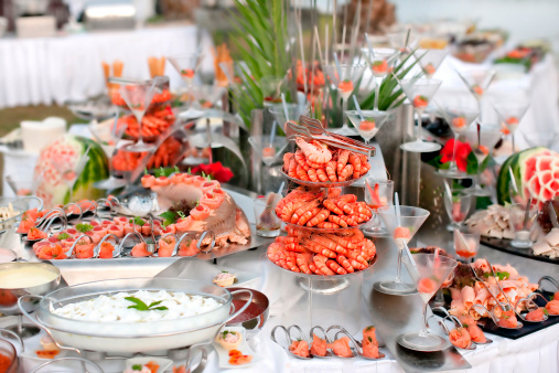 Buffet table with seafood with shrimp in the foreground