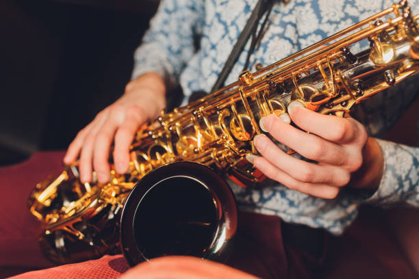 istock Saxophone player jazz musician. Saxophonist with baritone sax player. 1212440980