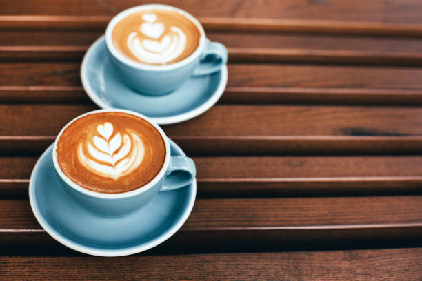 istock Two cups of cappuccino with latte art 1212441054