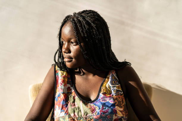 istock African woman sitting at home and resting 1212441064