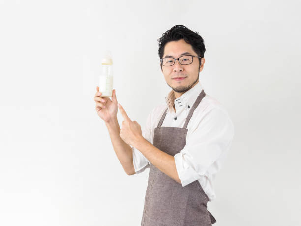 istock Japanese man with baby bottle 1212441411