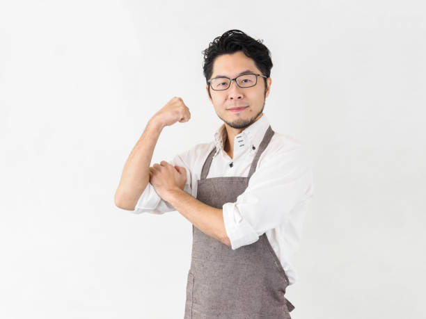 Japanese man motivated to do housework Japanese man motivated to do housework: father doing housework rolled up sleeves stock pictures, royalty-free photos & images