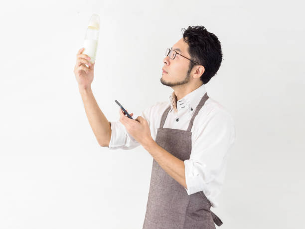 istock Japanese man examining how to make milk with smartphone 1212441434